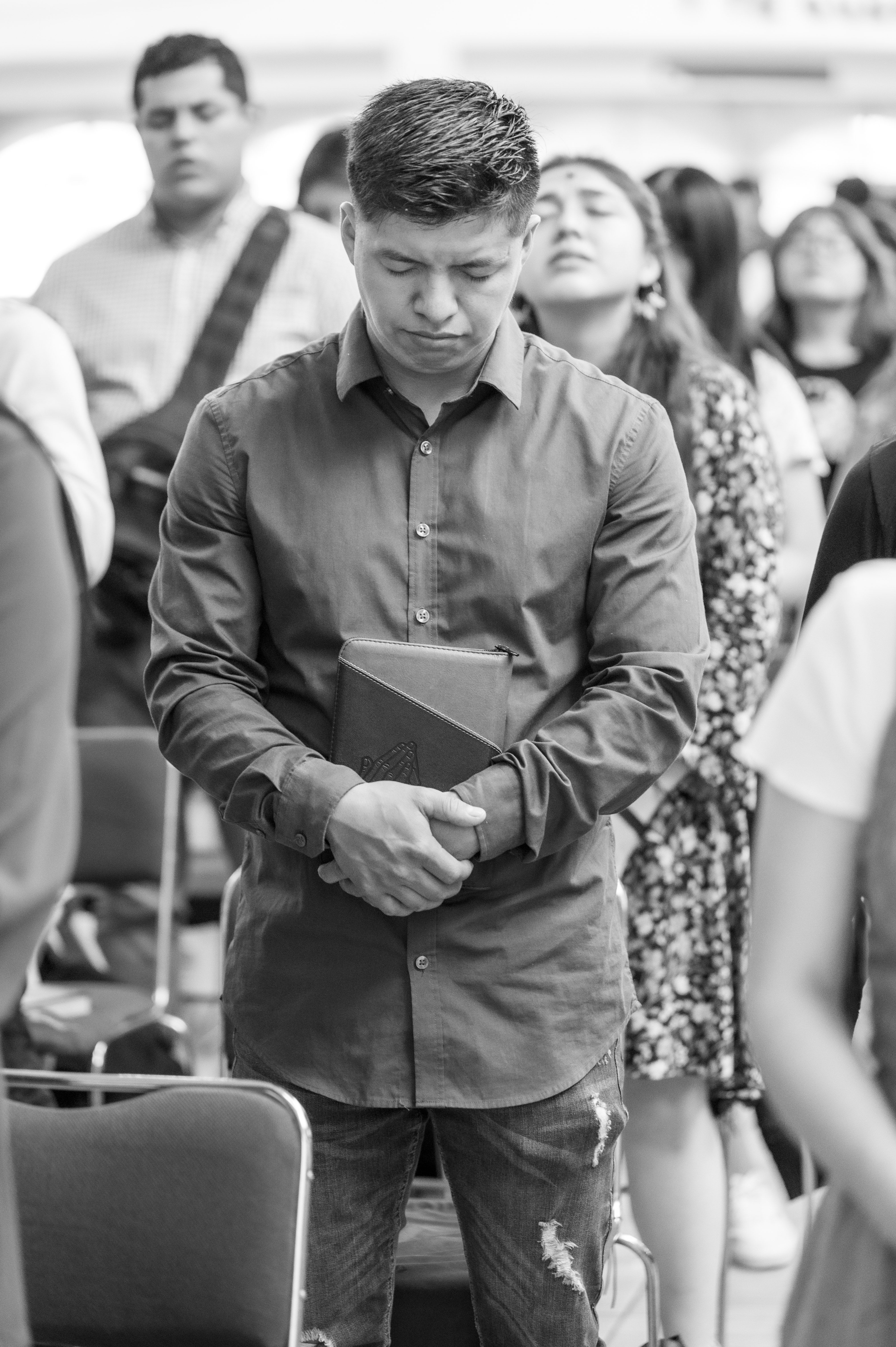 Man in Shirt Holding Bible and Praying · Free Stock Photo