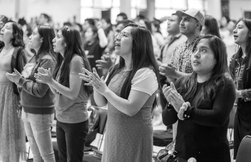 Free Women gathered together in Ciudad de México, praying and clapping in a religious setting. Stock Photo
