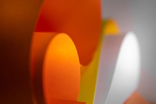 Dynamic abstract composition of colorful paper shapes with a smooth gradient background.