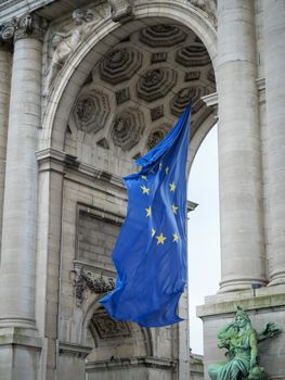 Close-up of the European Union flag waving at the Triumphal Arch in Brussels, Belgium.
