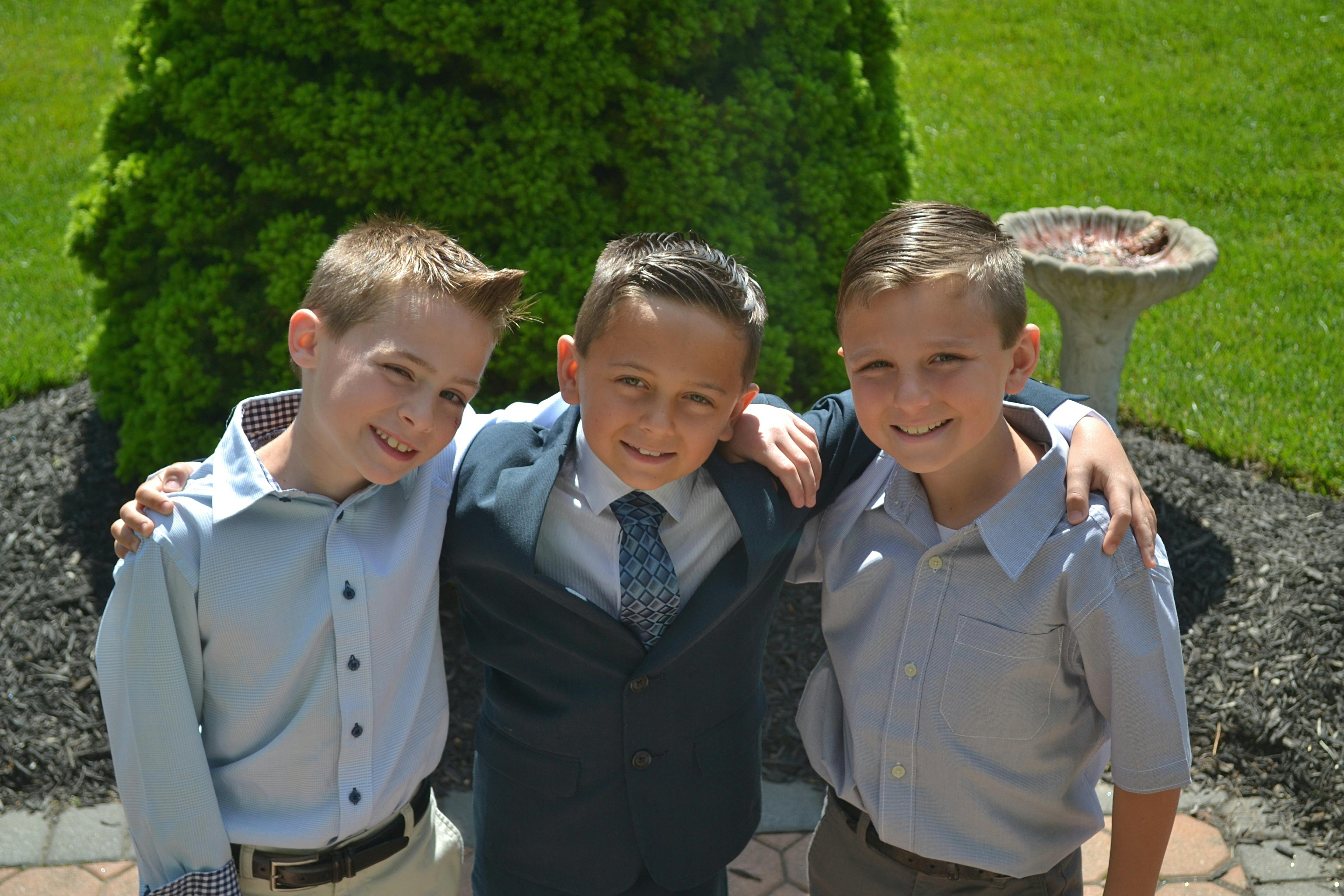 three boys taking selfie outdoors