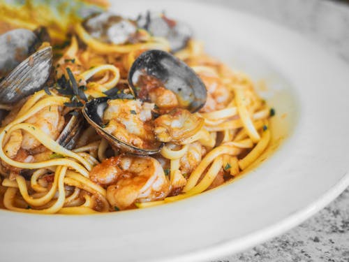 Pasta With Sauce on White Ceramic Plate