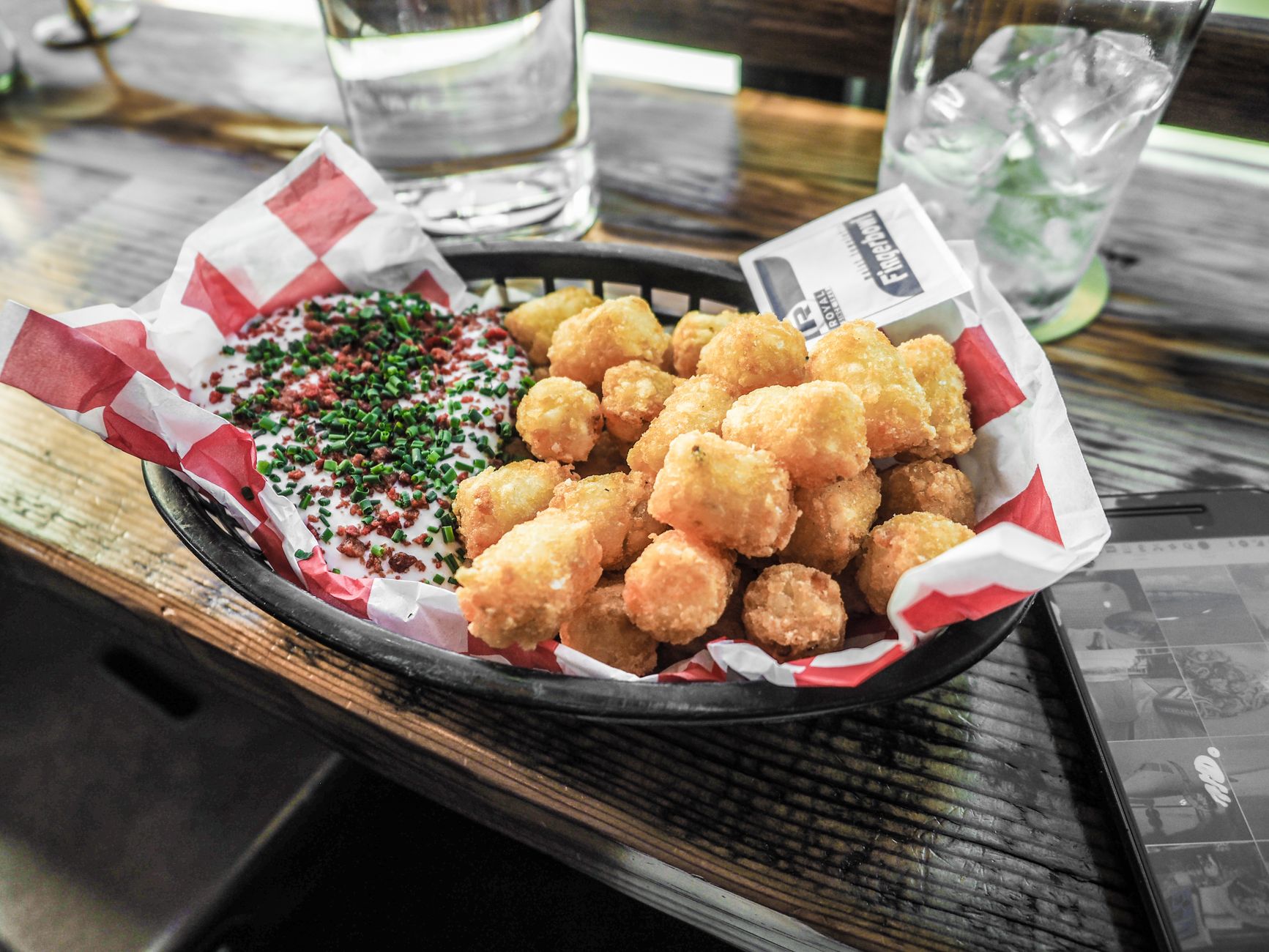 Delicious plate of crispy fried chicken with honey drizzle and side salad