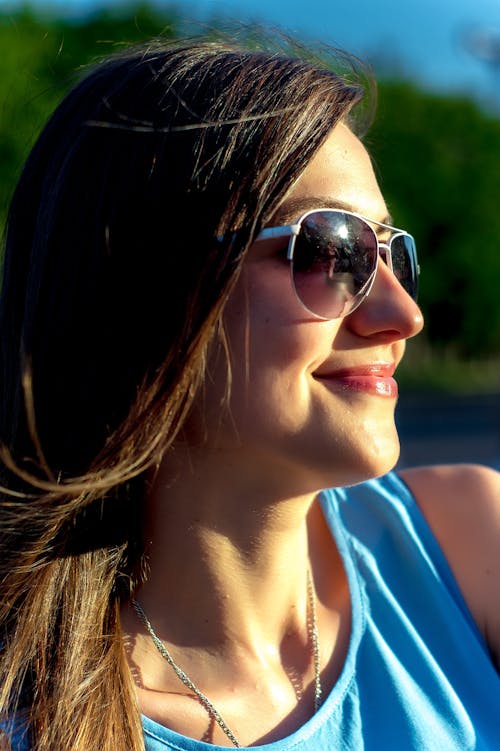 Woman in Blue Tank Top Smiling