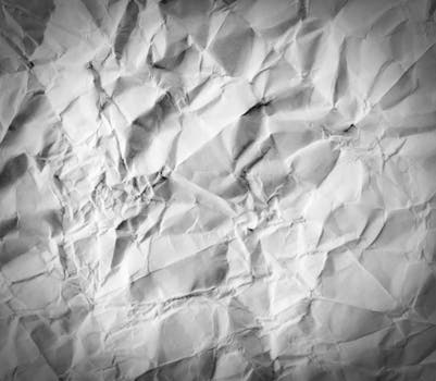 High-resolution crumpled white paper texture ideal for backgrounds, designs, and creative projects.