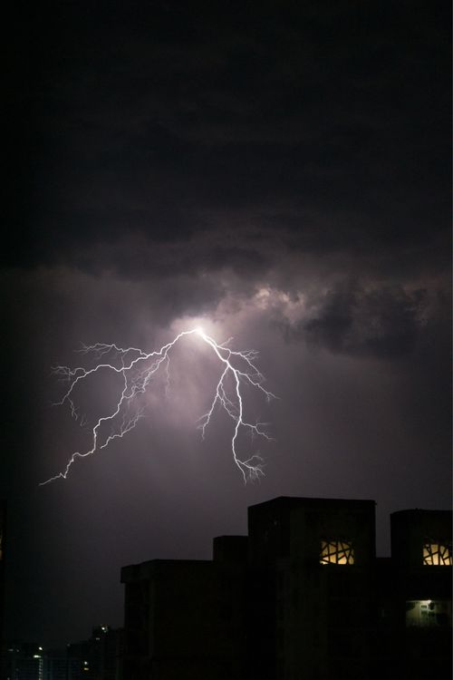 Free Captivating view of lightning striking over a cityscape at night, creating an electrifying urban atmosphere. Stock Photo