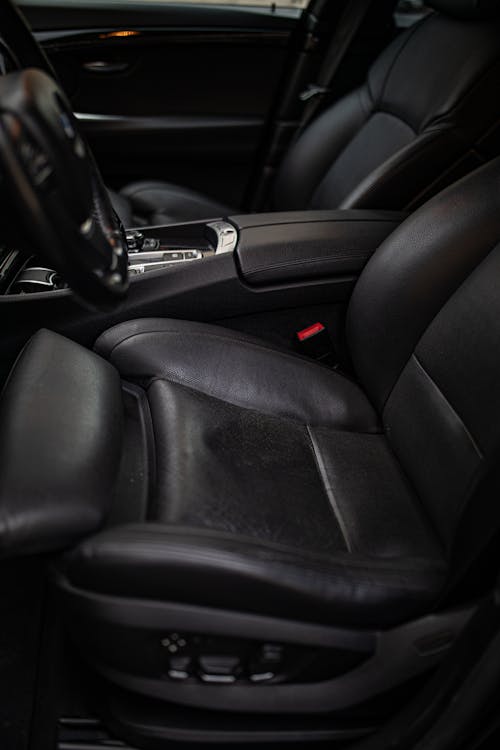 The interior of a black car with leather seats