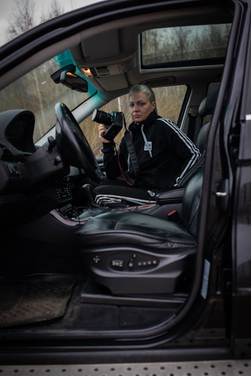 A woman sitting in the driver's seat of a car