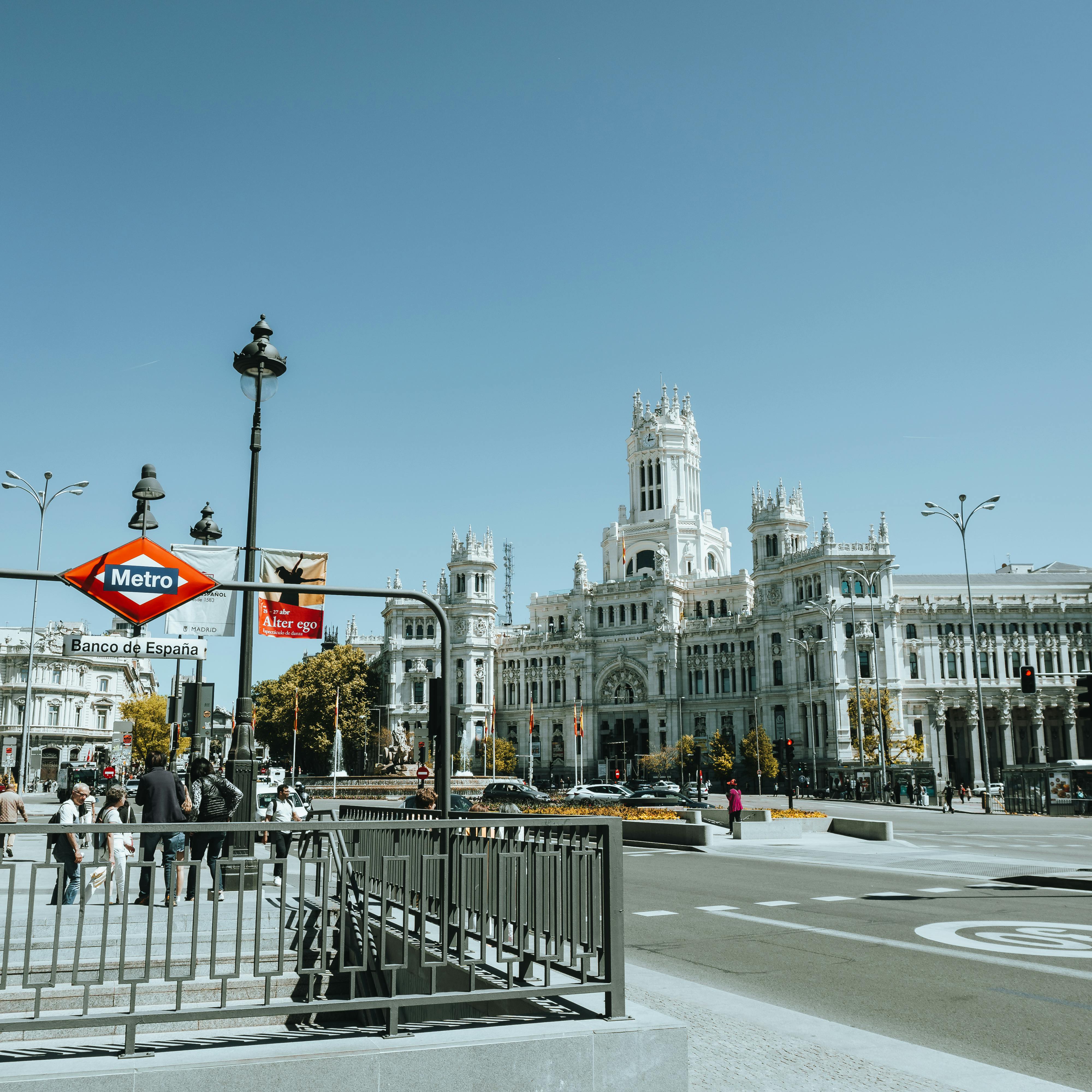 Scenic view of Cybele Palace with Madrid metro sign, capturing urban life.