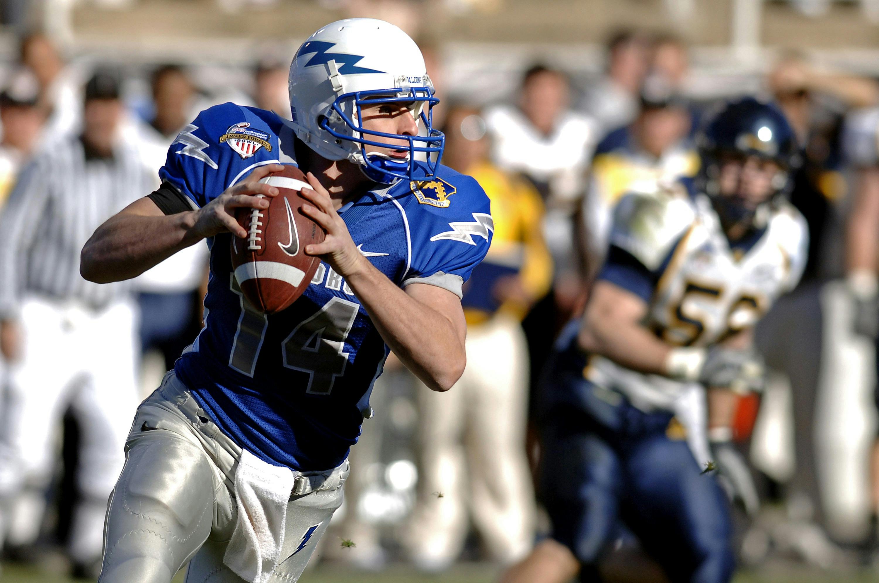 selective focus photography of man holding nike football ball