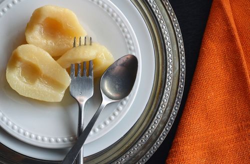 Free Close-up of sliced pears on a white plate with cutlery, highlighting healthy dessert options. Stock Photo