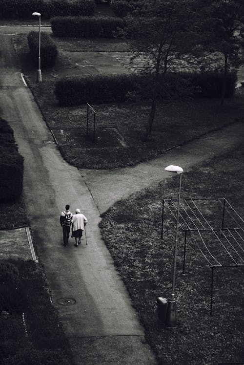 Man Walking Beside Woman on Road