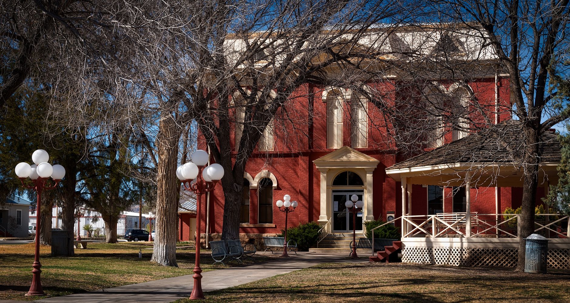 Charming red brick building with classic architecture set among trees in Brewster County, Texas.