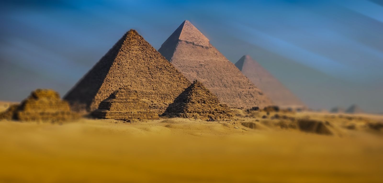 Pyramids of Giza amid sand/wilderness — Egypt historical site