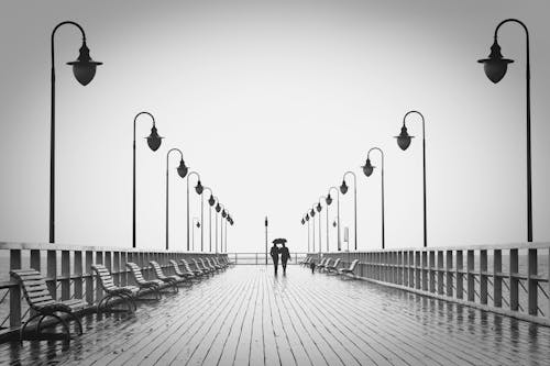 Free Two People Walking on Pier Stock Photo