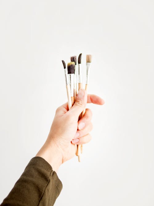 Photo of Person Holding Paint Brush