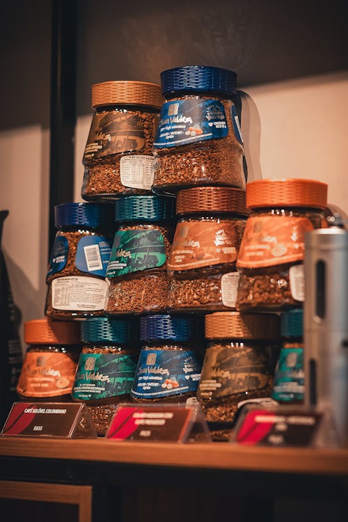 A shelf with jars of coffee and other items