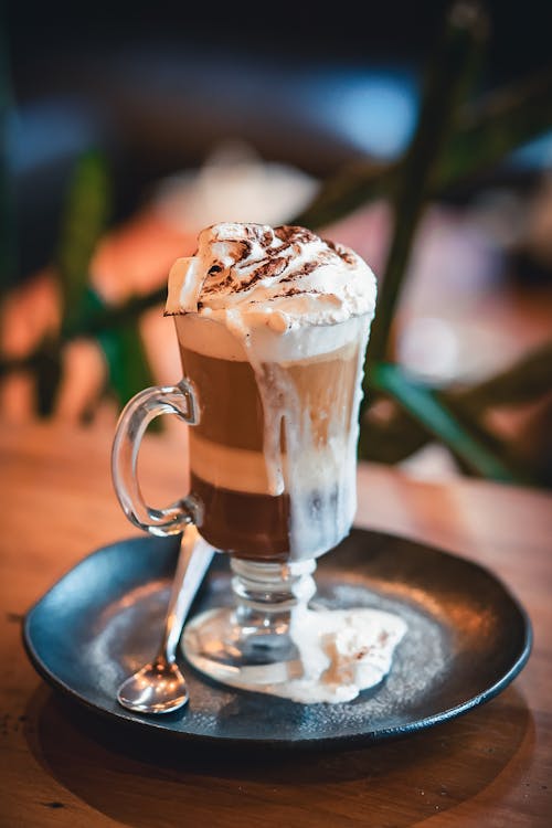A coffee drink with whipped cream and chocolate on top