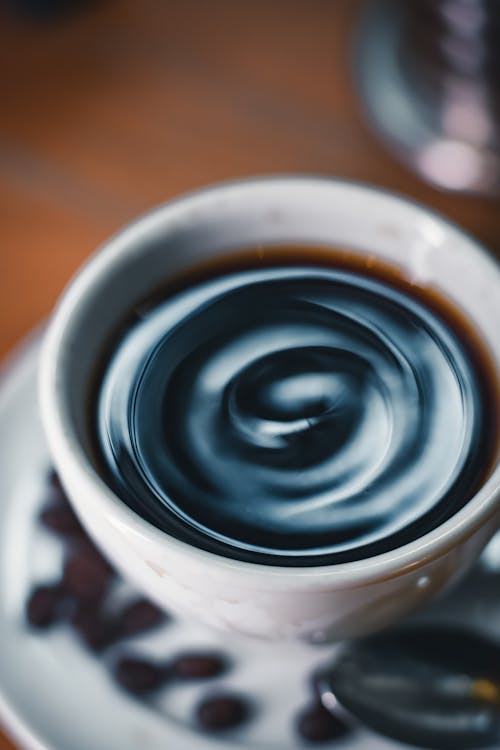 A cup of coffee with swirls of liquid