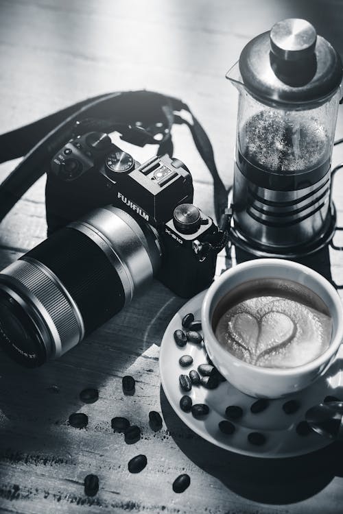 A coffee cup and camera on a table