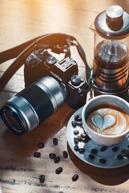 A coffee cup and camera on a table