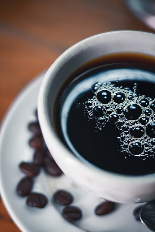 A cup of coffee with bubbles on top