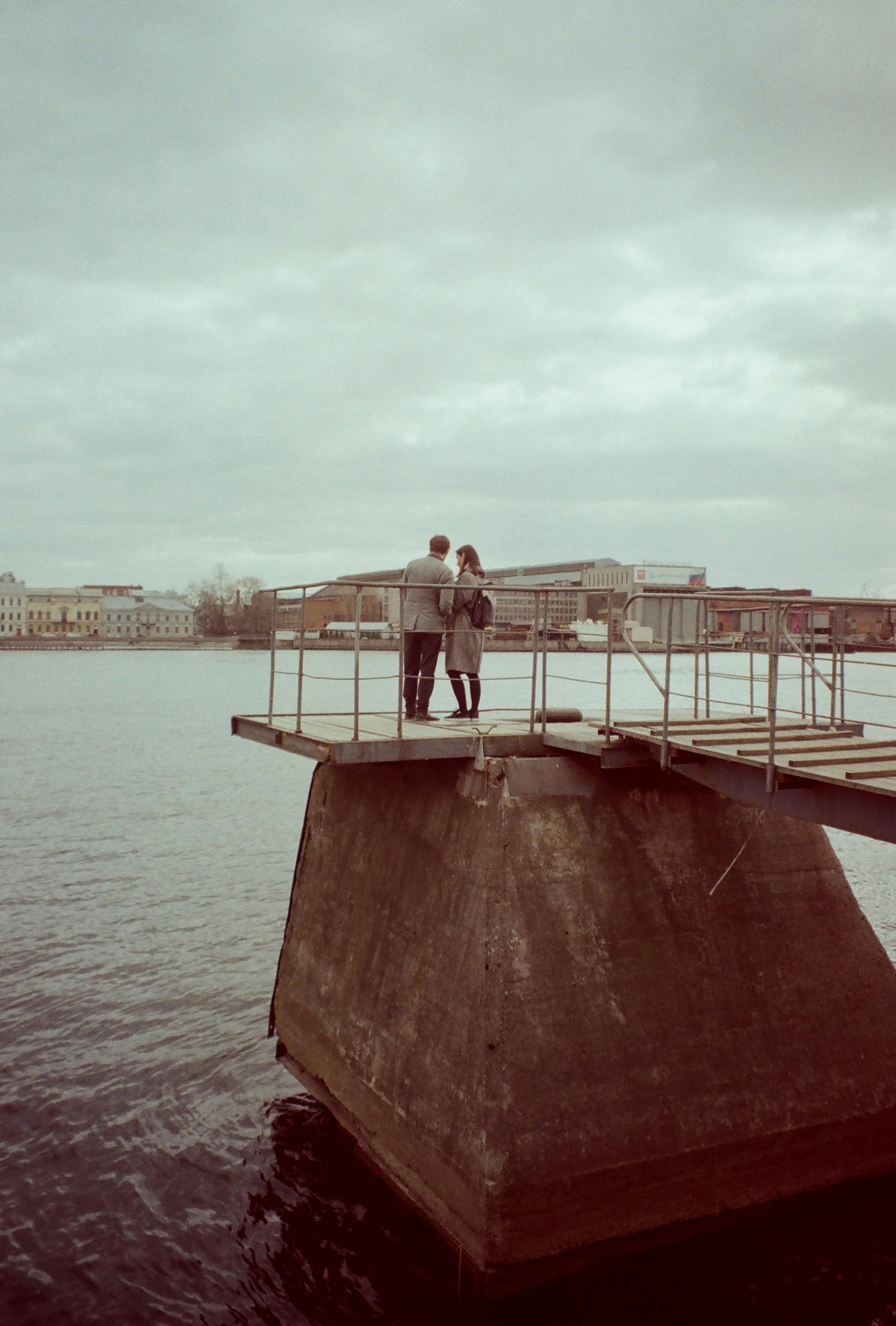 Woman and Man Standing on Dock