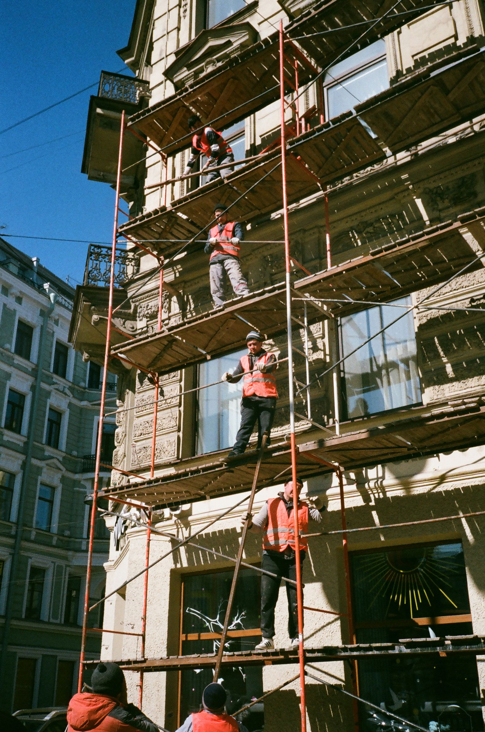 Construction team working on scaffolding during a building redevelopment