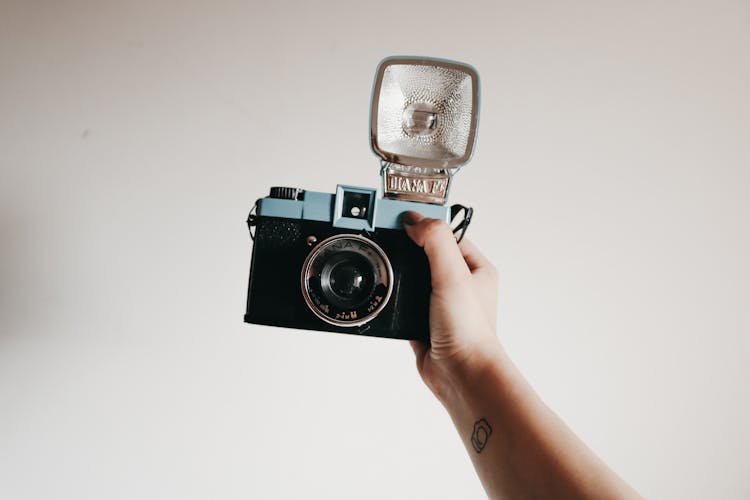 Person Holding Black Camera