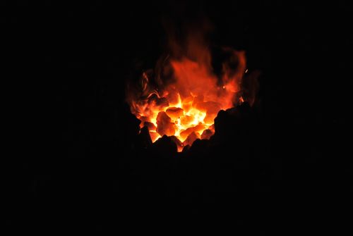 Glowing embers in a dark hearth — photo by Pixabay on Pexels