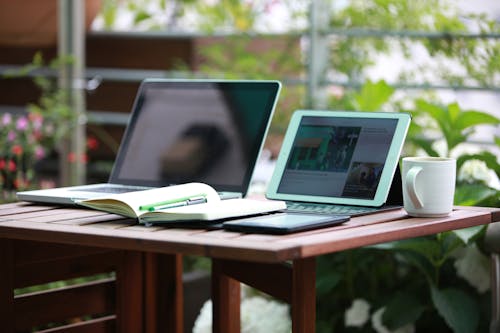 Two Black Laptop Computers Turned on