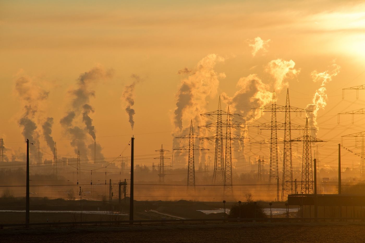 Industrial plant and piping under a pale sky