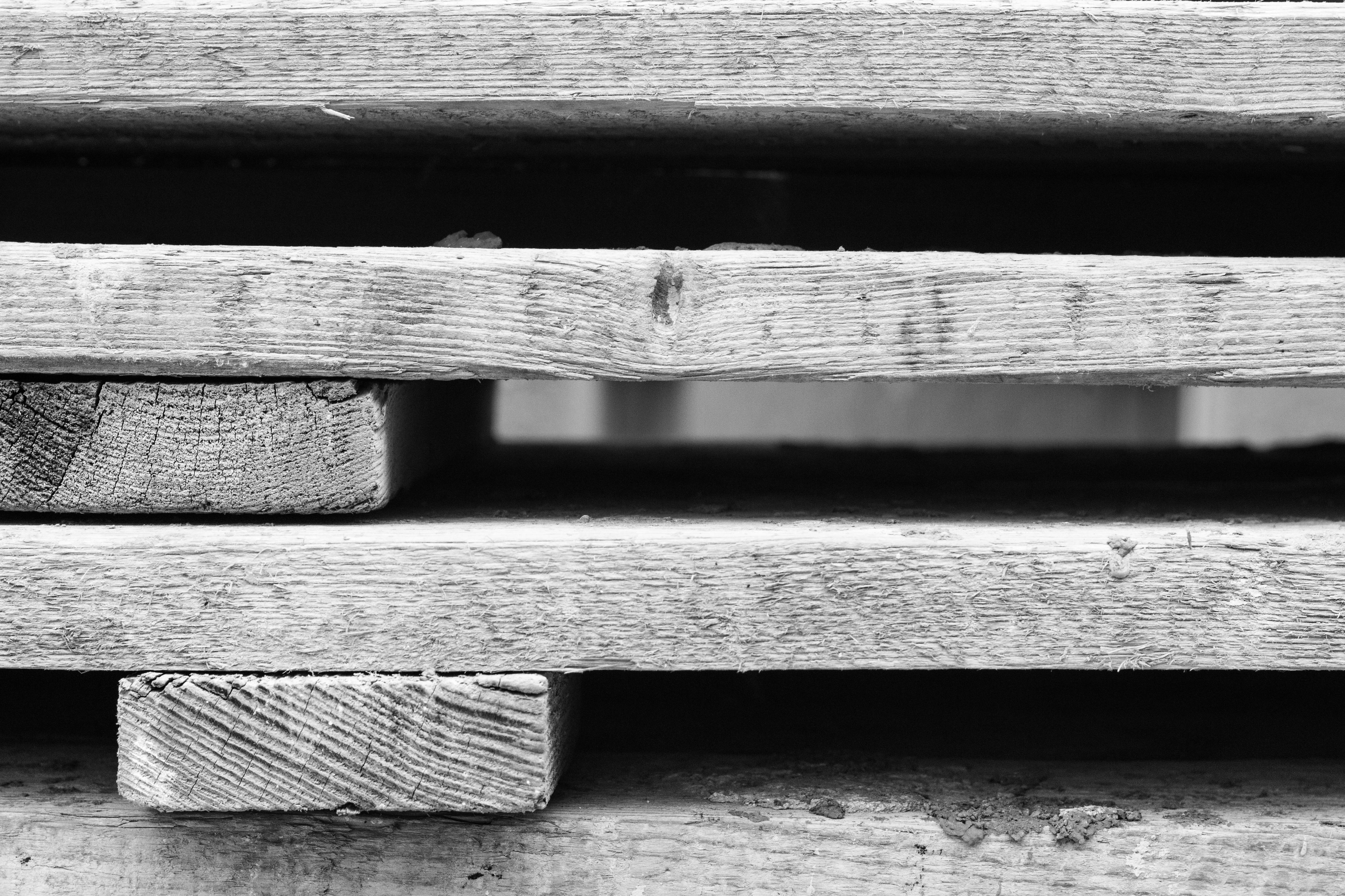 Grayscale Photo of Wooden Pallets