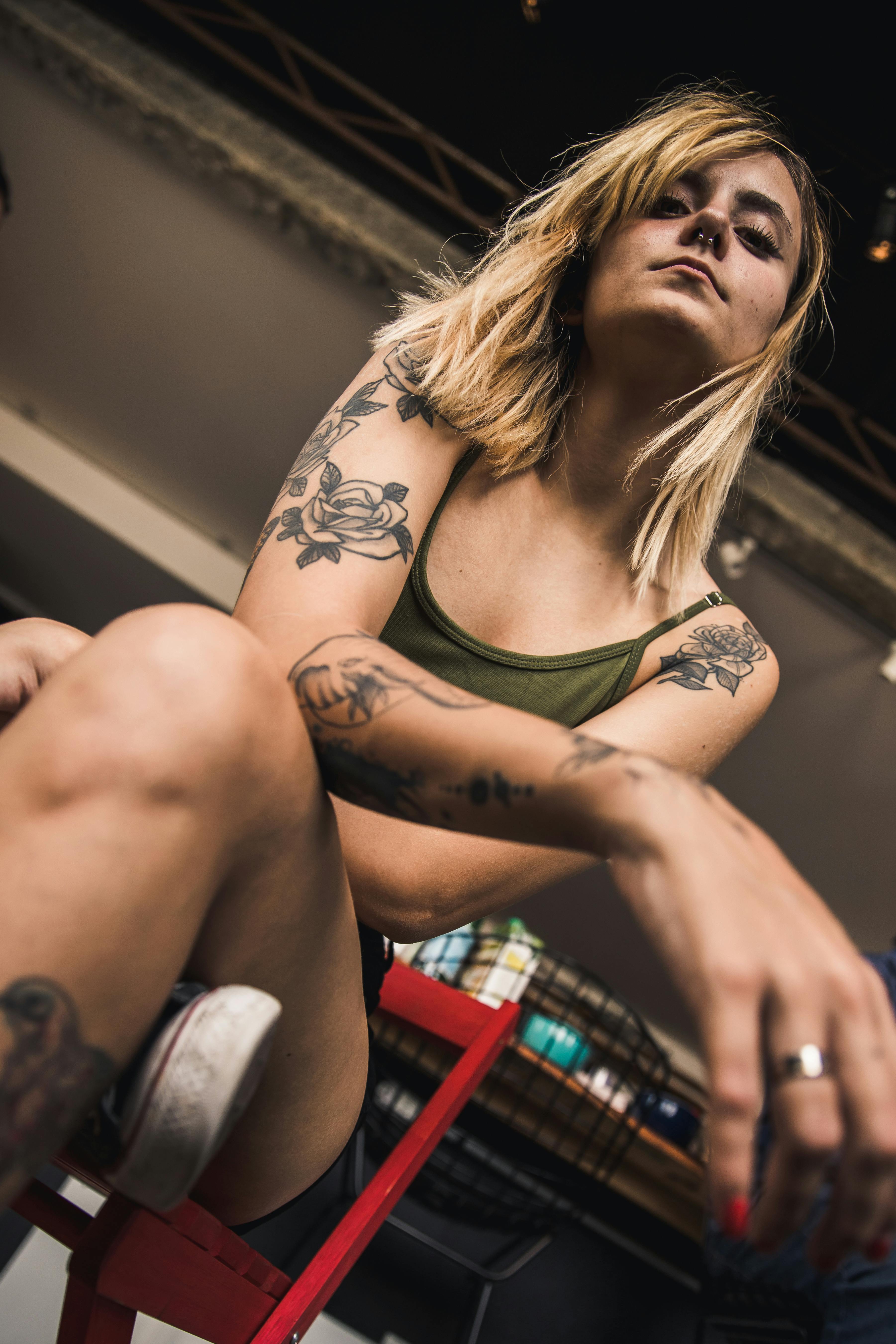 woman wearing green tank top sittin on chair