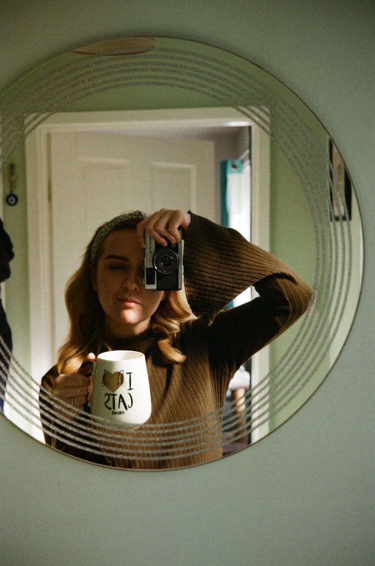 Woman With Camera In Mirror