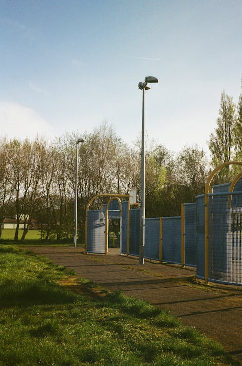 A blue gate with a fence in front of it