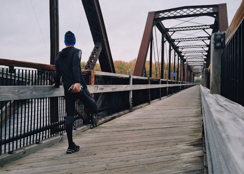 Free Man Standing on Bridge Stock Photo