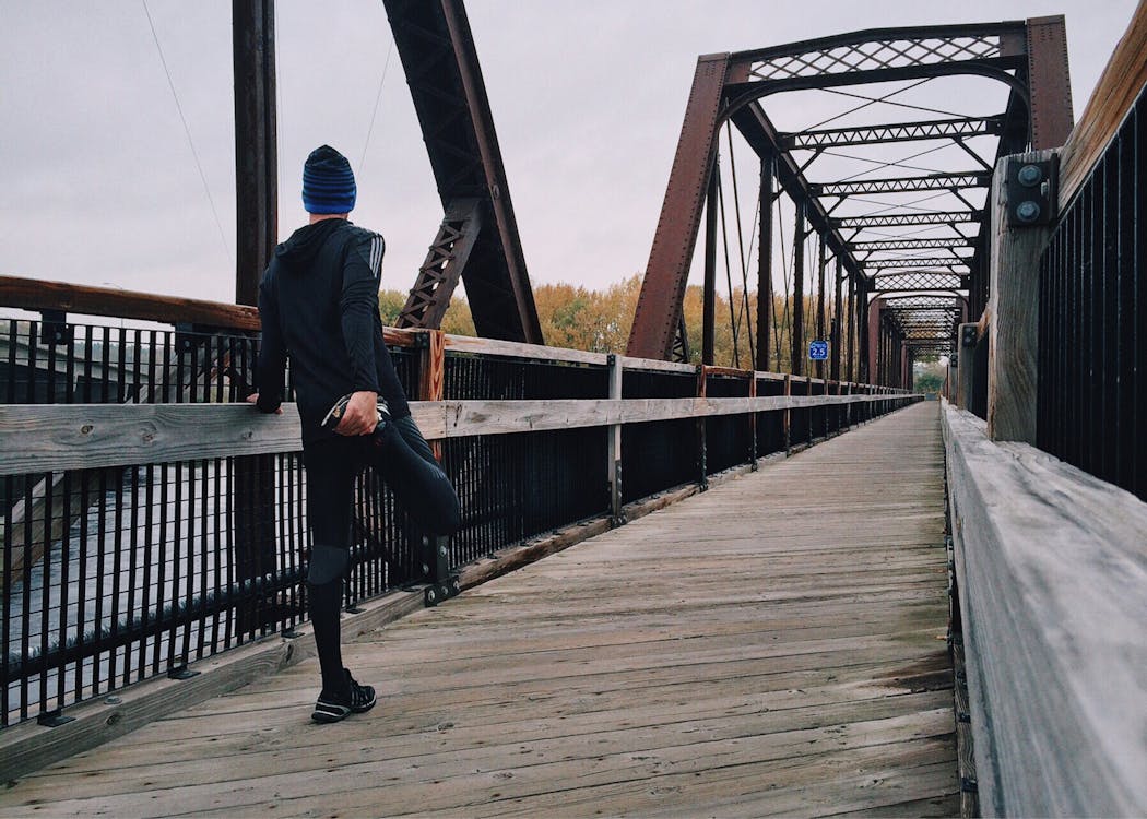 Man Standing on Bridge