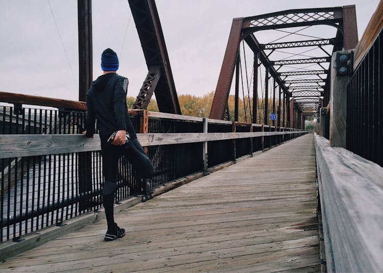 Man Standing On Bridge