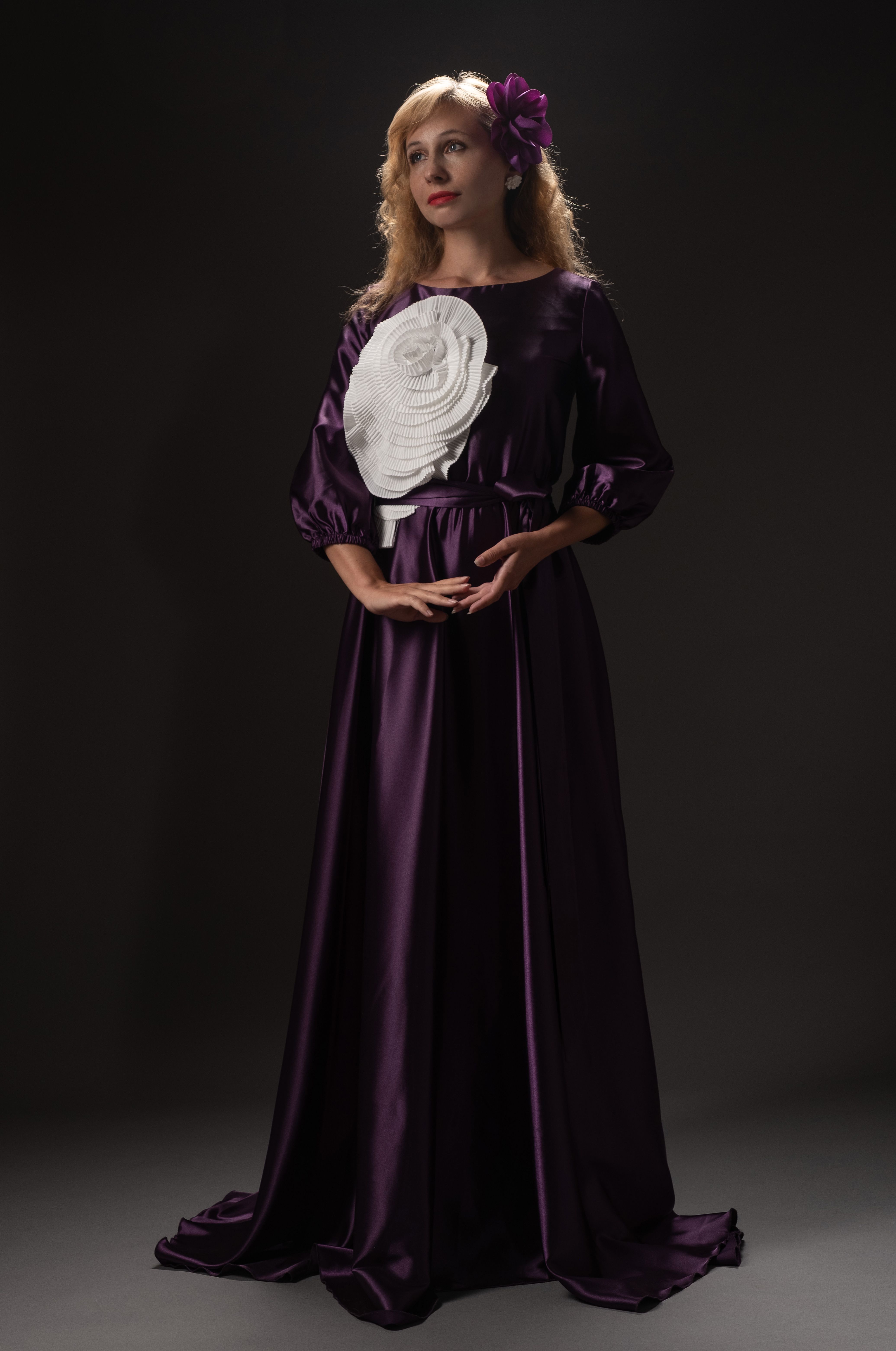 Editorial image of a flowing purple evening gown