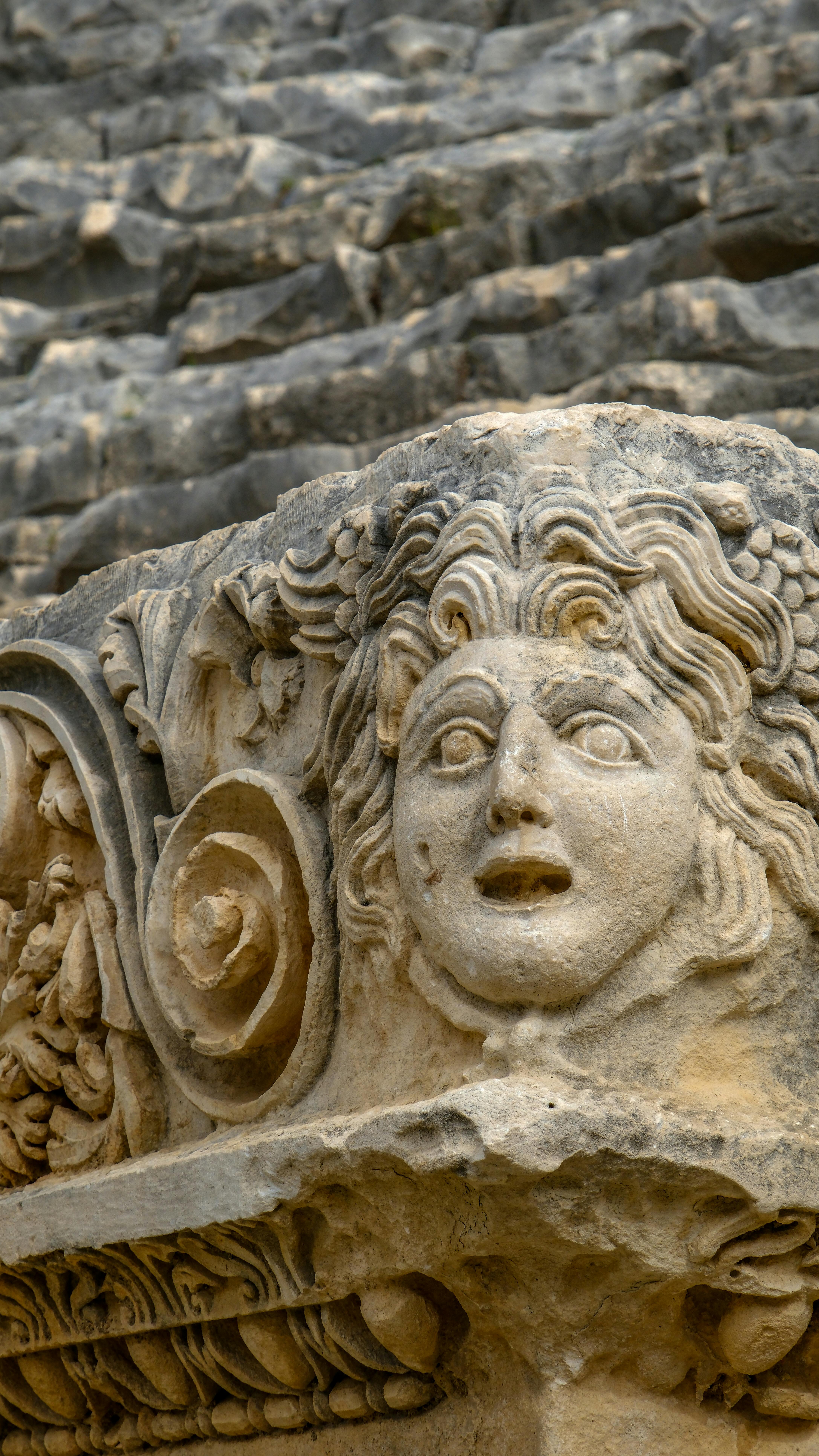 Free Intricate stone relief depicting a face at the ancient Myra theater in Antalya, Türkiye. Stock Photo
