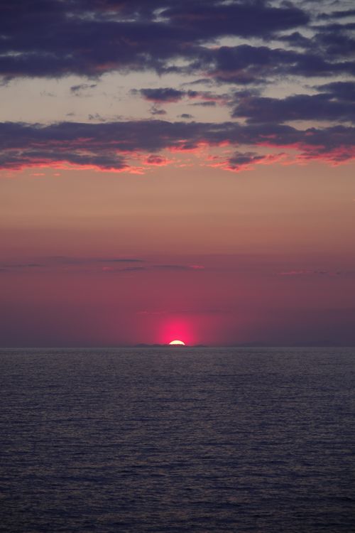 Free Tranquil sunset over Uzunyurt, Muğla, Türkiye with vibrant clouds and calm sea. Stock Photo