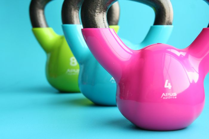 Row of colourful kettlebells in a gym