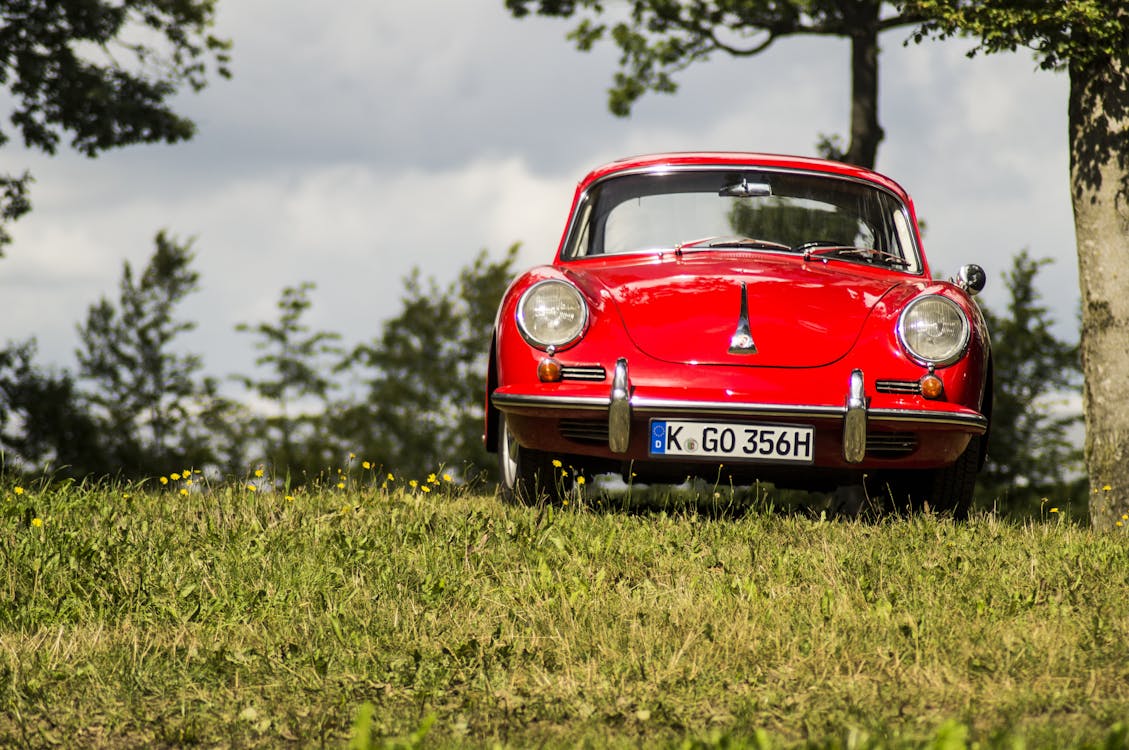 Red Vehicle Parked Beside Tree