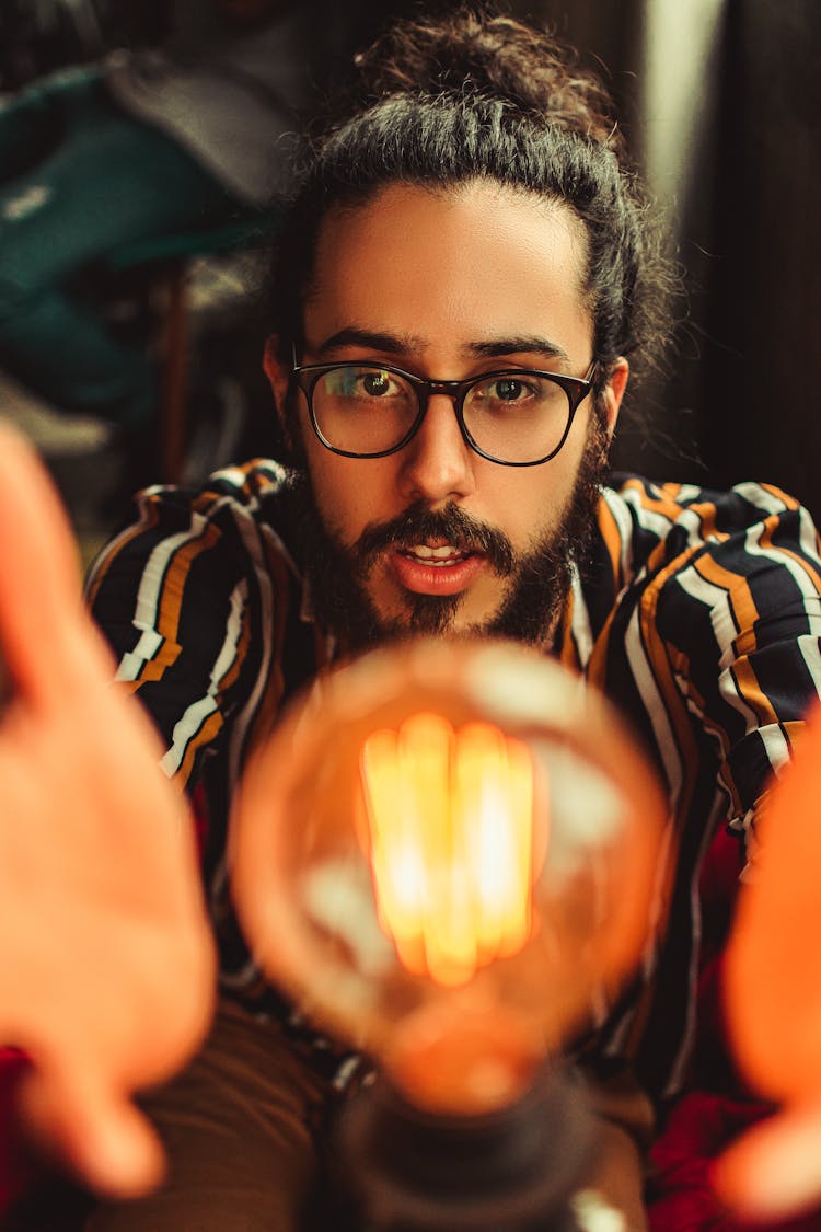 Man Holding Light Bulb