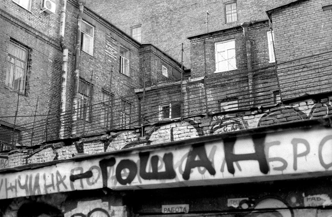 A black and white photo of a building with graffiti