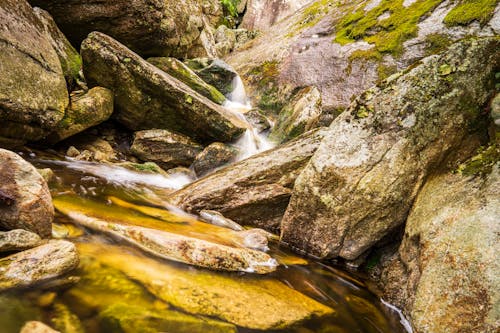 A stream flowing through a rocky area with some rocks