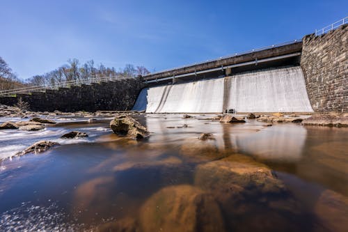 A large dam with water flowing over rocks