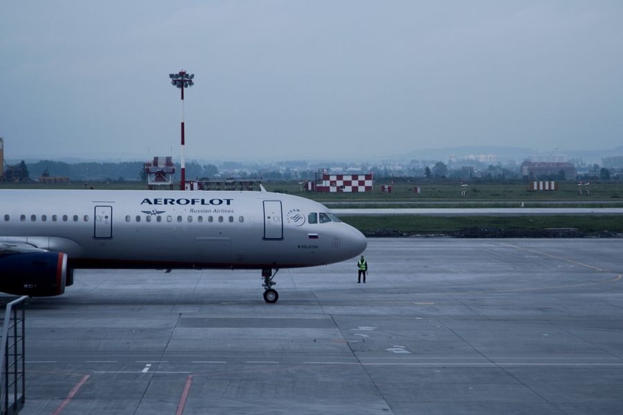 Aeroflot airplane stationed on an airport tarmac with overcast skies.