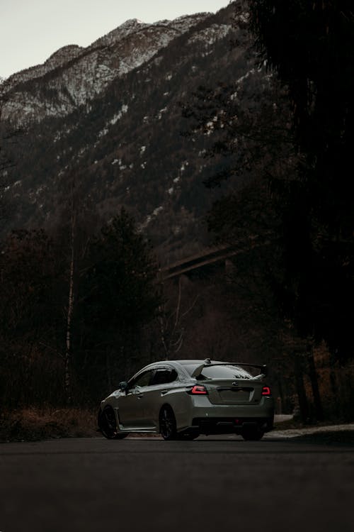 A car driving down a road in the mountains